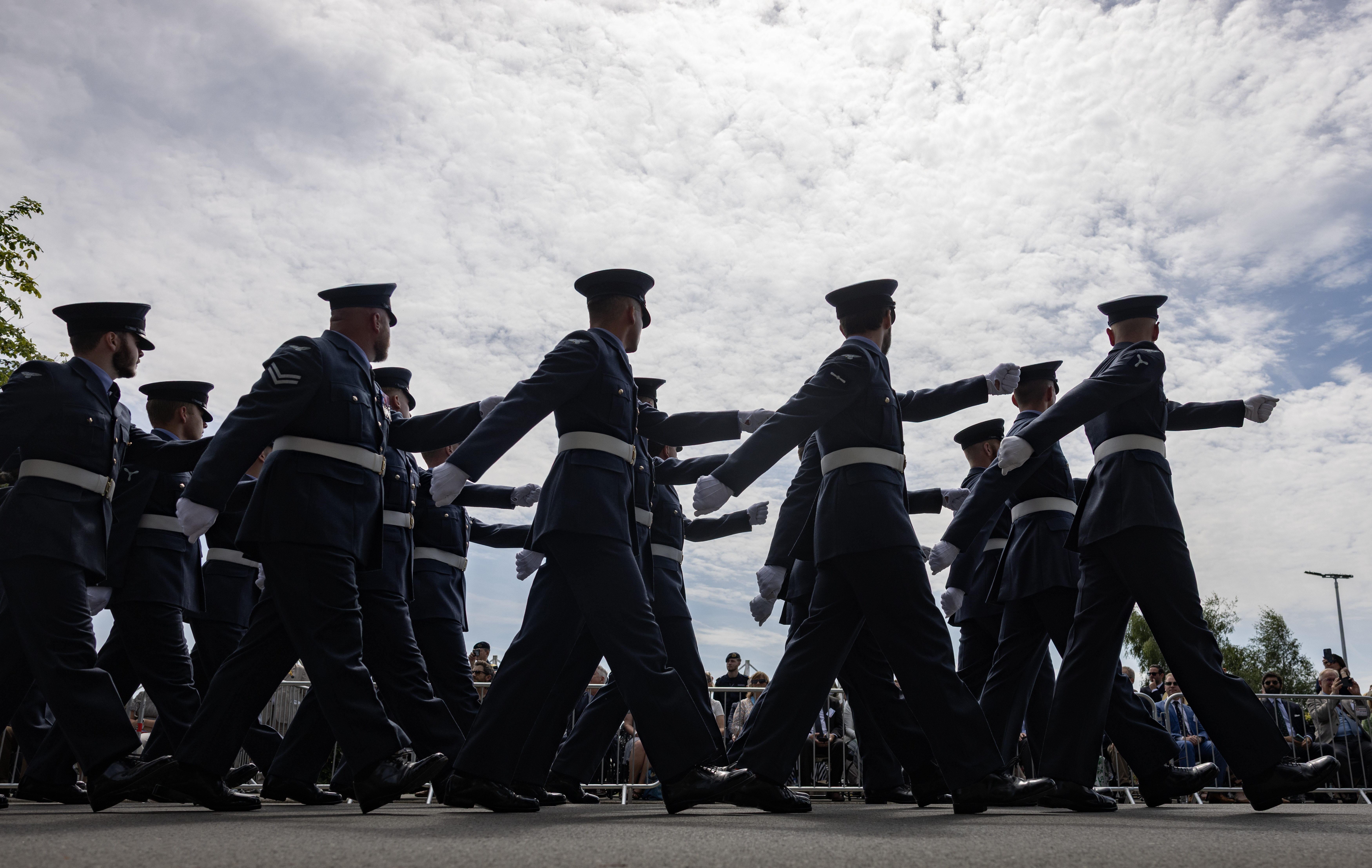 Military members marching at a Royal British Legion Armed Forces Day event.