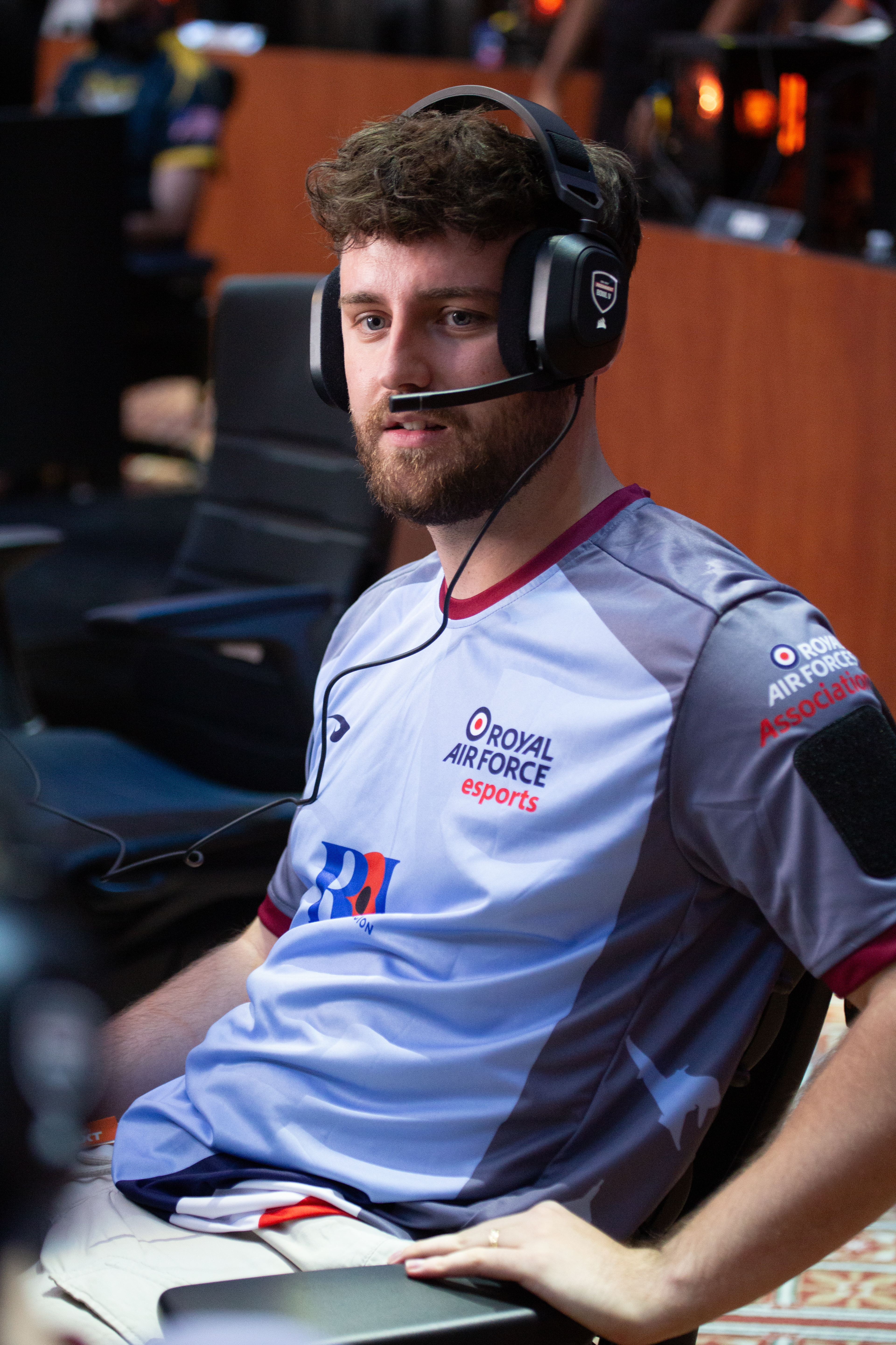 A Royal Air Force esports player wearing a gaming headset.