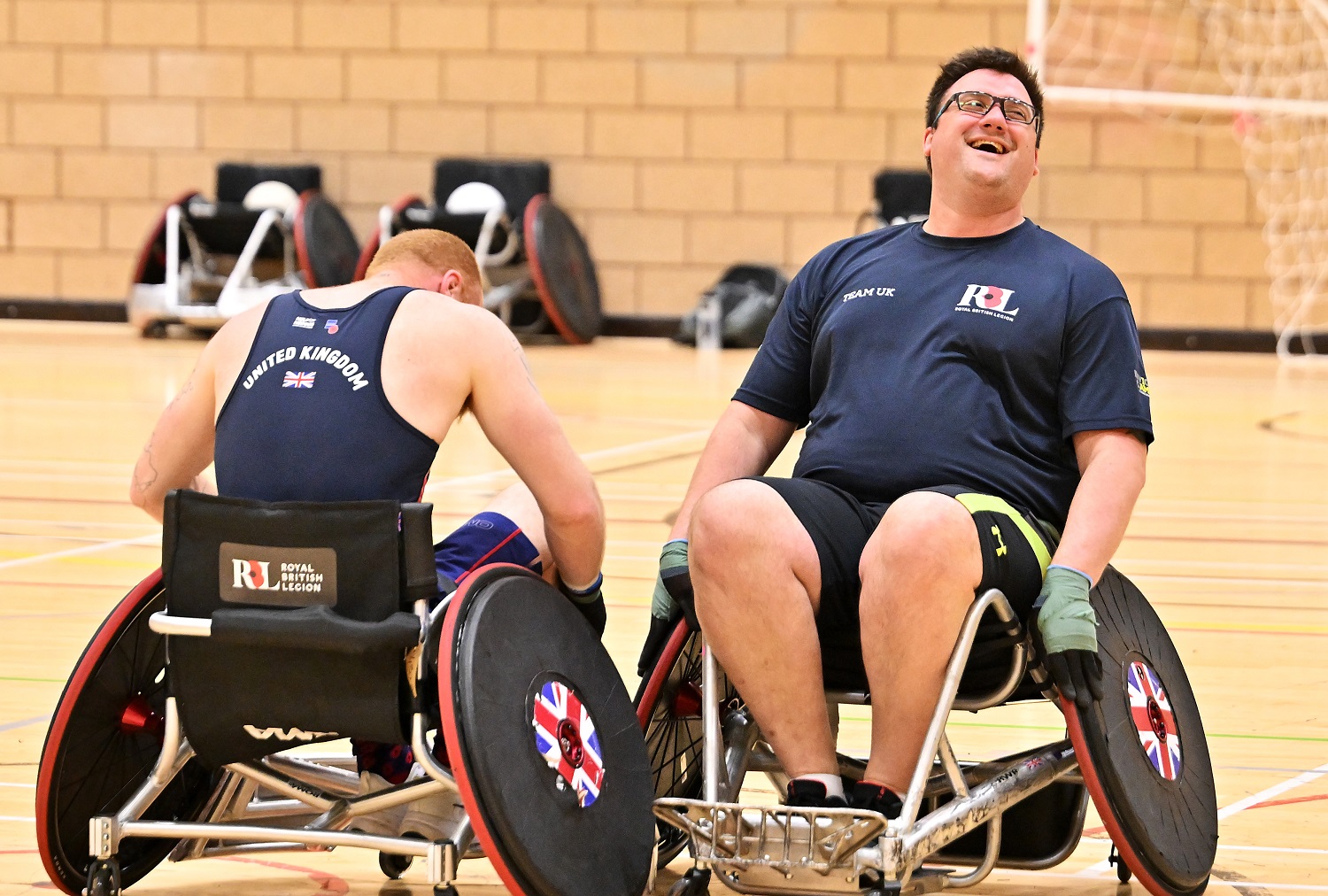 Matthew Trigg playing wheelchair rugby, he is laughing with another player
